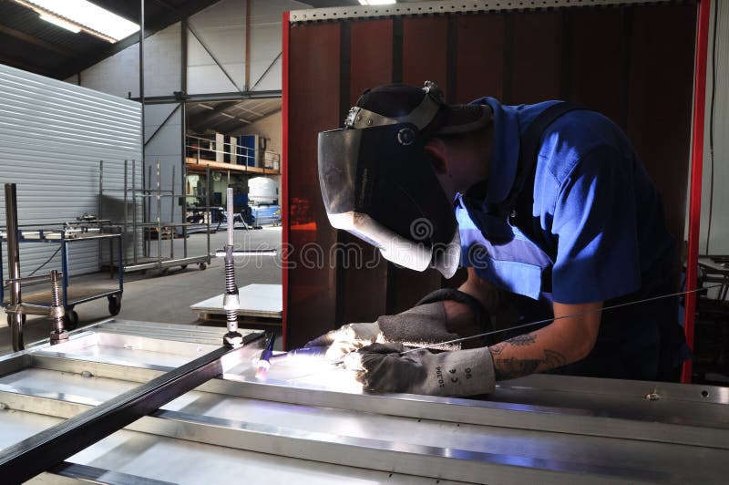 Welder concentrated at work at metalworking company. Welder concentrated at work at metalworking company