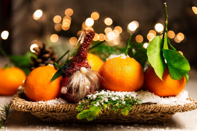 Fresh Clementines or Tangerines and 2 Gnomes with Xmas Lights on the background, Christmas concept. Fresh Clementines or Tangerines and 2 Gnomes with Xmas Lights on the background, Christmas concept