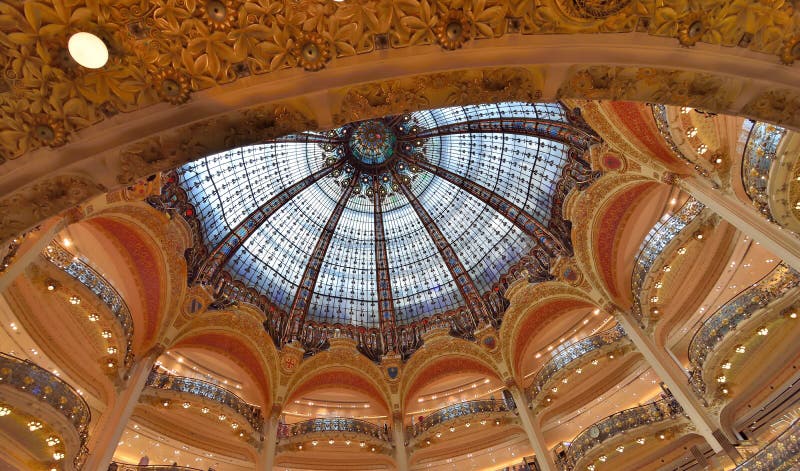 The Galeries Lafayette is an upmarket French department store with a colorful light dome located on Boulevard Haussmann in Paris, France. The Galeries Lafayette is an upmarket French department store with a colorful light dome located on Boulevard Haussmann in Paris, France.