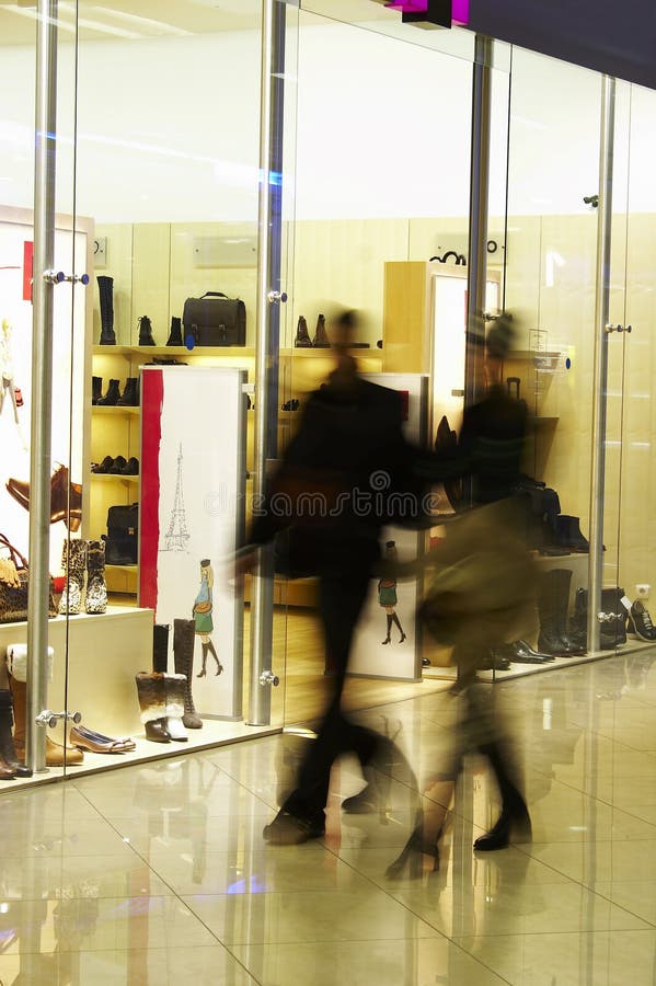 The man and the woman make purchases in shopping center. The man and the woman make purchases in shopping center.