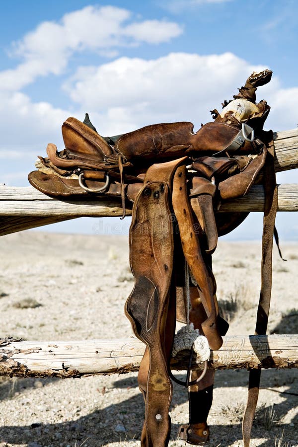 Saddle on a fence - a vintage saddle in rural Wyoming. Saddle on a fence - a vintage saddle in rural Wyoming