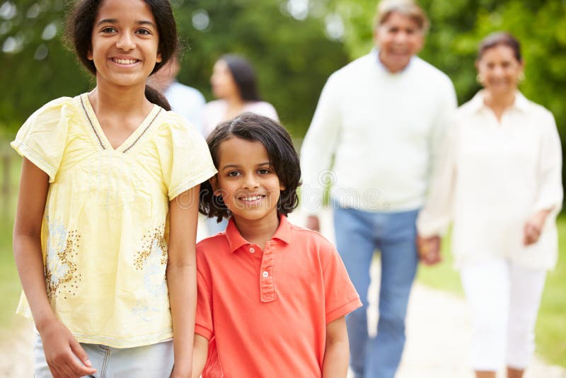 Close Up Of Muti-Generation Indian Family Walking In Countryside Smiling. Close Up Of Muti-Generation Indian Family Walking In Countryside Smiling