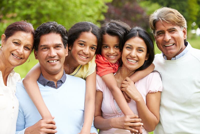 Muti-Generation Indian Family Walking In Countryside In Daylight Looking At Camera Smiling. Muti-Generation Indian Family Walking In Countryside In Daylight Looking At Camera Smiling