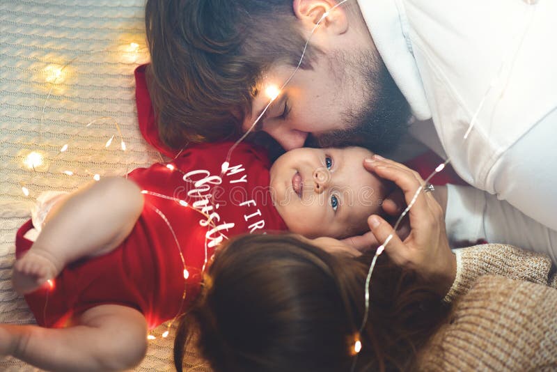 Семья, влюбленность, концепции счастья Родители целуя щеку младенца семья счастливая стоковые фото Семья, влюбленность, концепции счастья Родители целуя щеку младенца семья счастливая стоковые фото