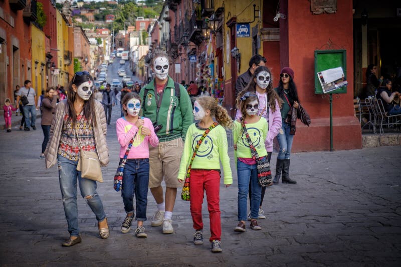 A family in San Miguel de Allende, Mexico, a UNESCO World Heritage site, walks down the main street wearing Catrina skeleton make-up with white faces and black and blue eyes, to celebrate the holiday Day of the Dead, which falls in November. A family in San Miguel de Allende, Mexico, a UNESCO World Heritage site, walks down the main street wearing Catrina skeleton make-up with white faces and black and blue eyes, to celebrate the holiday Day of the Dead, which falls in November.