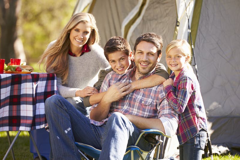 Family Enjoying Camping Holiday In Countryside Smiling To Camera. Family Enjoying Camping Holiday In Countryside Smiling To Camera