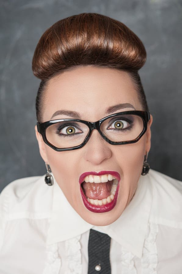 Angry screaming woman on the blackboard background. Angry screaming woman on the blackboard background