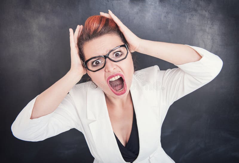 Angry screaming teacher on chalkboard blackboard background. Angry screaming teacher on chalkboard blackboard background