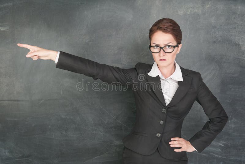 Angry teacher in glasses pointing out. Angry teacher in glasses pointing out