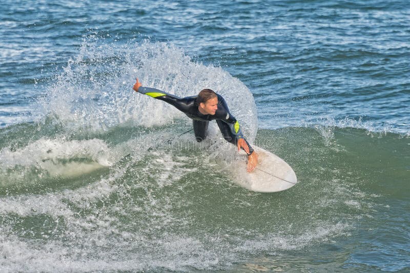 SEBASTIAN, FLORIDA - February 9th, 2018: surfer riding the waves at Sebastian Inlet in Sebastian Florida. SEBASTIAN, FLORIDA - February 9th, 2018: surfer riding the waves at Sebastian Inlet in Sebastian Florida