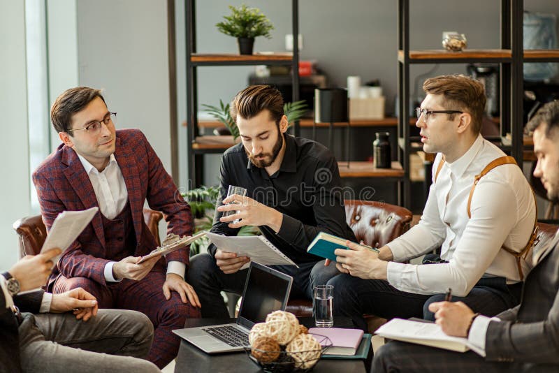 Serious business people hold meeting in office for discussing and speaking about business projects, ideas and strategies for future. successful confident men in elegant suits indoors. Serious business people hold meeting in office for discussing and speaking about business projects, ideas and strategies for future. successful confident men in elegant suits indoors
