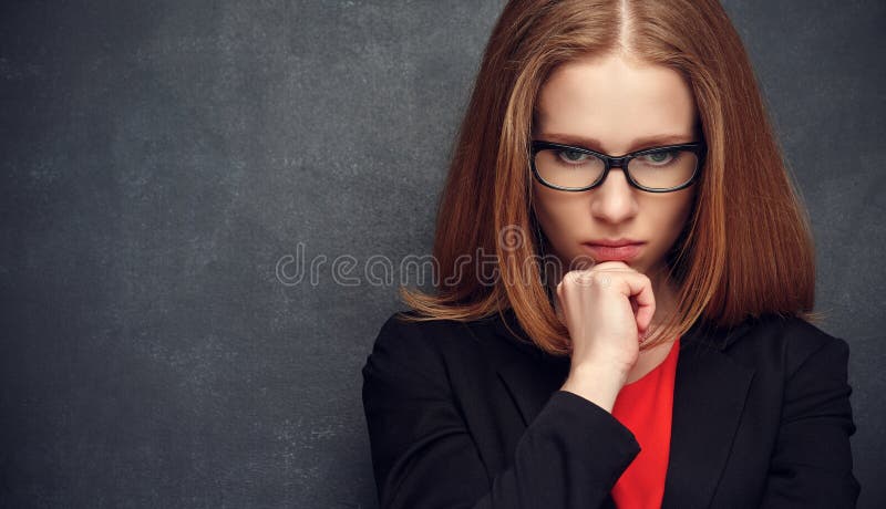 Serious stern woman teacher at the blackboard. Serious stern woman teacher at the blackboard