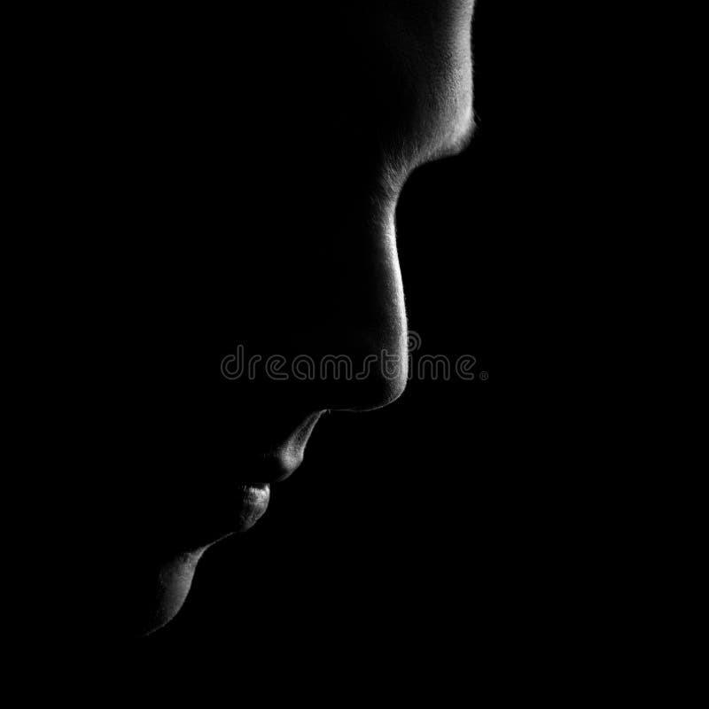 Silhouette of male profile, black and white low key shot. Silhouette of male profile, black and white low key shot