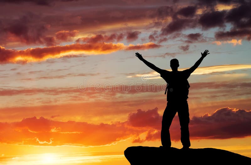 Silhouette of a man on a mountain top on sunset sky background. Silhouette of a man on a mountain top on sunset sky background