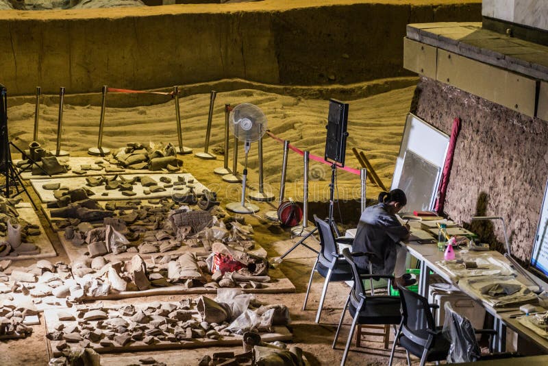 XI&#x27;AN, CHINA - AUGUST 6, 2018: Archaeologist working in the Pit 2 of the Army of Terracotta Warriors near Xi&#x27;an, Shaanxi province, China. XI&#x27;AN, CHINA - AUGUST 6, 2018: Archaeologist working in the Pit 2 of the Army of Terracotta Warriors near Xi&#x27;an, Shaanxi province, China