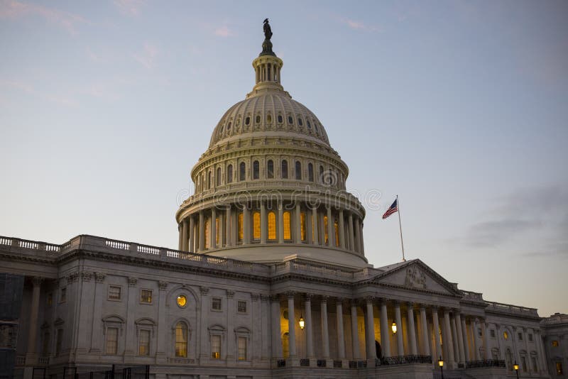 US Congress at dusk with flag waving. US Congress at dusk with flag waving