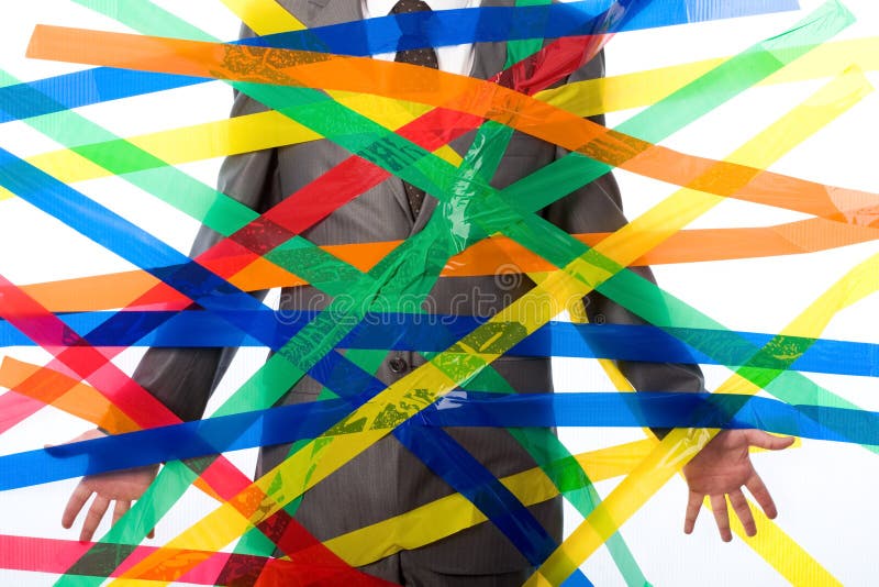 Close-up of man glued to wall with colorful sticky tape. Close-up of man glued to wall with colorful sticky tape