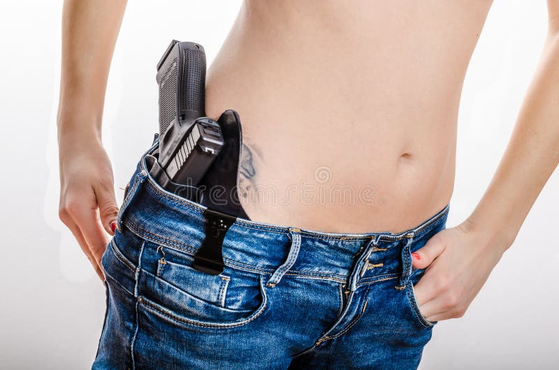 Скрытый снесите оружие в его waistband стоковая фотография rf Скрытый снесите оружие в его waistband стоковая фотография rf