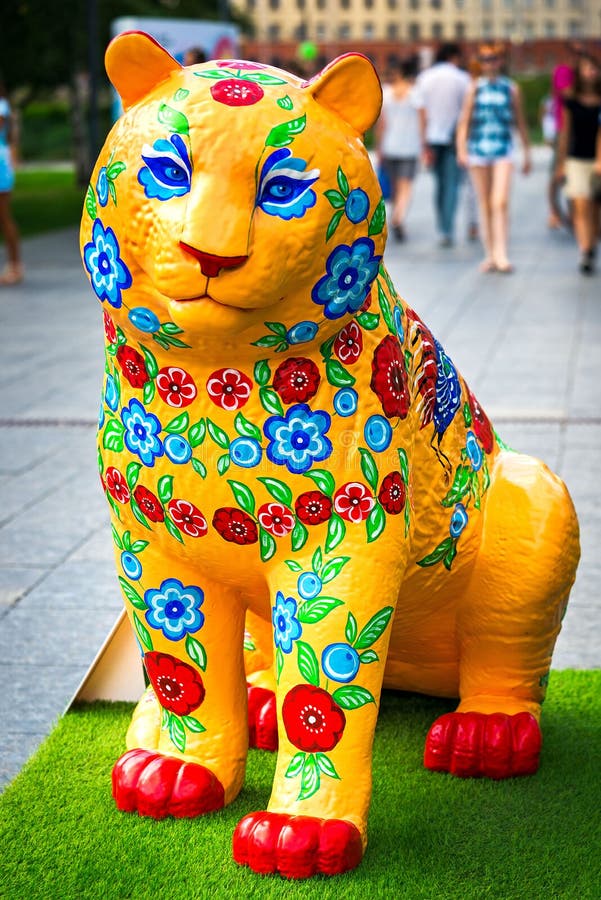 Moscow, Russia - July 31, 2016: Tiger sculpture, decorated in the style of Gorodets painting (folk arts and crafts). Festival Tigers in Muzeon. Celebration of the international tiger day in Moscow. Moscow, Russia - July 31, 2016: Tiger sculpture, decorated in the style of Gorodets painting (folk arts and crafts). Festival Tigers in Muzeon. Celebration of the international tiger day in Moscow.