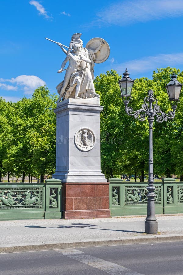 Sculptural group Athena Protects the Young Hero erected on the high marble pedestal and granite plinth installed on the bridge Schlossbruecke at Unter den Linden boulevard in Berlin, Germany. Sculptural group Athena Protects the Young Hero erected on the high marble pedestal and granite plinth installed on the bridge Schlossbruecke at Unter den Linden boulevard in Berlin, Germany