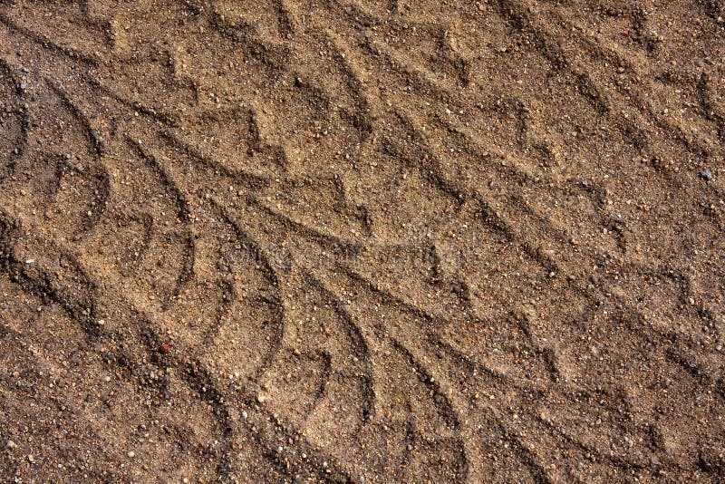 Closeup of multiple tire tracks in sand showing pattern and texture. Closeup of multiple tire tracks in sand showing pattern and texture