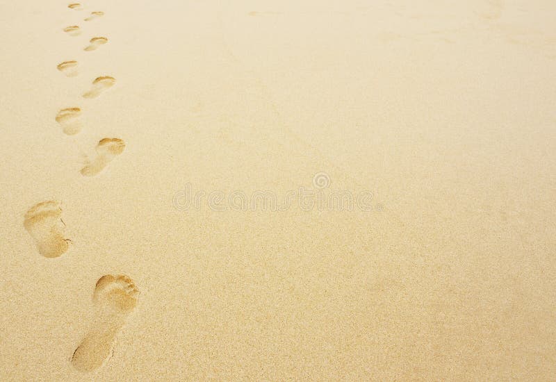 Footprints in the sand background great for vacation or holiday adverts. Footprints in the sand background great for vacation or holiday adverts