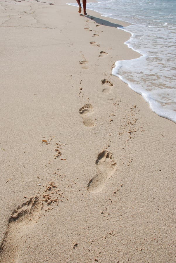 Walking on beach. Footprints on sand. Walking on beach. Footprints on sand.