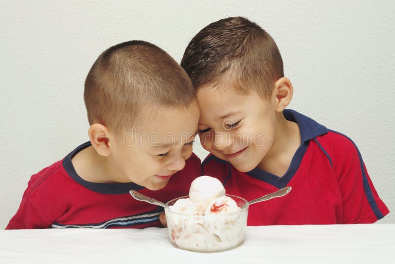 Two preschool brothers ready to enjoy a large bowl of strawberry-cheesecake ice cream. Two preschool brothers ready to enjoy a large bowl of strawberry-cheesecake ice cream