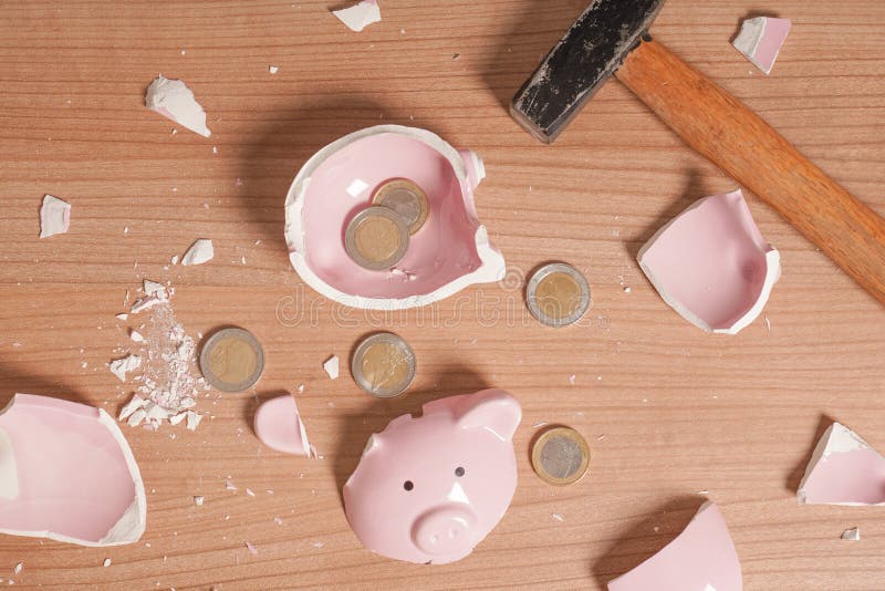 broken Piggy bank smashed into pieces - flat lay with hammer and small or loose change euro coins. broken Piggy bank smashed into pieces - flat lay with hammer and small or loose change euro coins