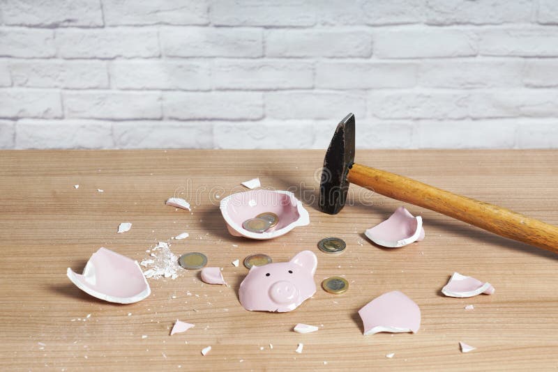 broken Piggy bank smashed into pieces with hammer and small or loose change euro coins. broken Piggy bank smashed into pieces with hammer and small or loose change euro coins