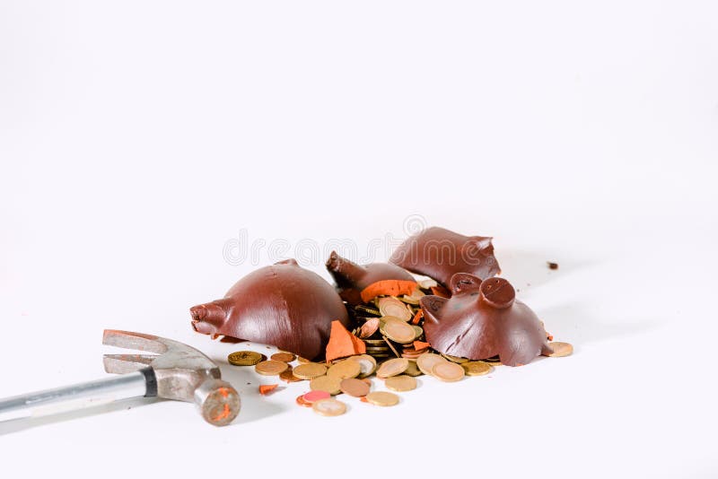 Broken piggy bank with a hammer isolated on white background. Broken piggy bank with a hammer isolated on white background.