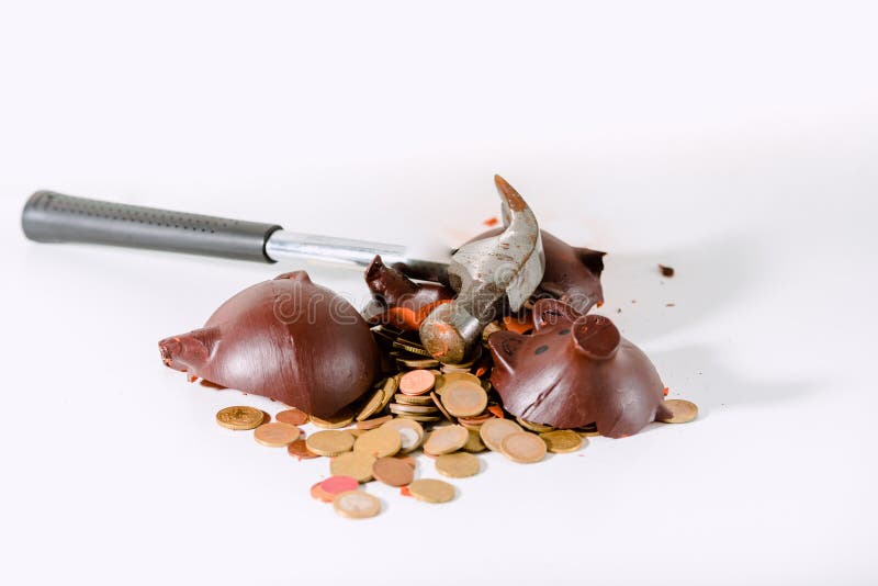 Broken piggy bank with a hammer isolated on white background. Broken piggy bank with a hammer isolated on white background.