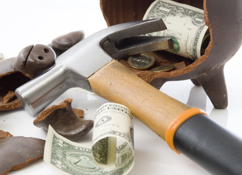 A broken and empty clay piggy money box with money and hammer over white background. A broken and empty clay piggy money box with money and hammer over white background