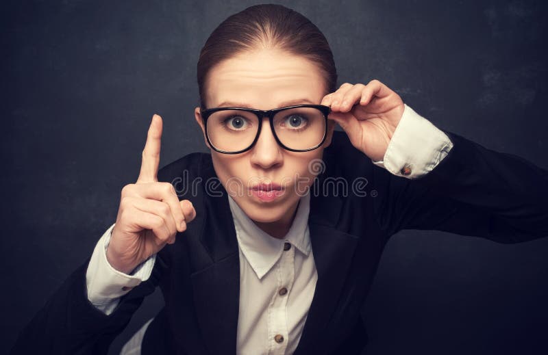 Funny strict teacher with glasses shakes his finger at the school board. Funny strict teacher with glasses shakes his finger at the school board