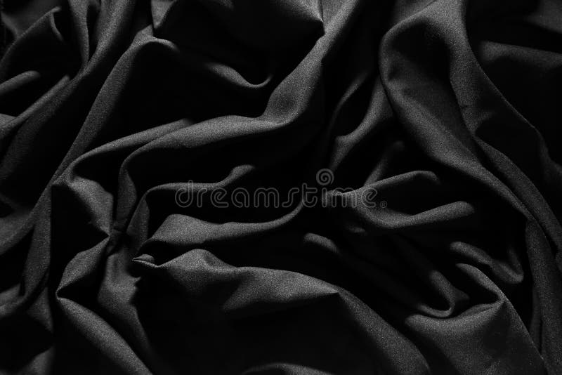 Wrinkled gray fabric, Light hits, Dark pattern background. Wrinkled gray fabric, Light hits, Dark pattern background