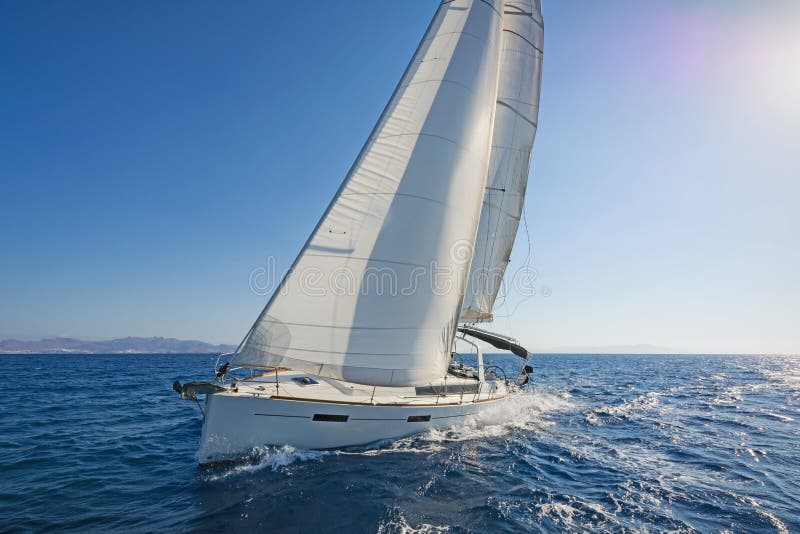 View of a modern sailing yacht in action. Blue waters of the Aegean sea, Greece. View of a modern sailing yacht in action. Blue waters of the Aegean sea, Greece.