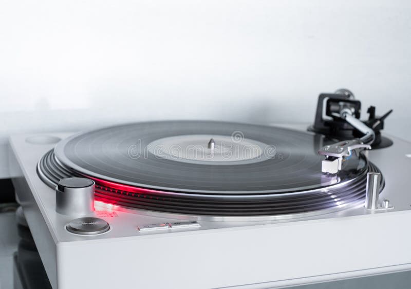 Modern white Turntable vinyl record player. on rotation. Sound technology for DJ to mix & play music. Vinyl record and needle. Modern white Turntable vinyl record player. on rotation. Sound technology for DJ to mix & play music. Vinyl record and needle.