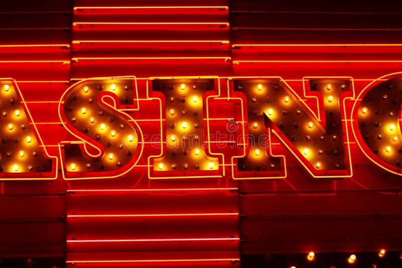 The word SIN isolated from a lighted CASINO sign with neon lights forming a CROSS in the background. The word SIN isolated from a lighted CASINO sign with neon lights forming a CROSS in the background