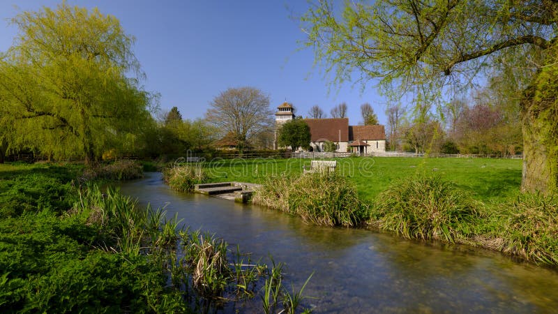 Meonstoke, UK - April 1, 2019:  The first day of April 2019 brings beautiful spring weather and light onto the Meon Valley village of Meonstoke and the unique church of St Andrew's.  This is a fine example of an Early English church, Grade II listed, with few later alterations, leaving it internally in all the serenity associated with that era. The roof and aisles were raised in the 18th century,. Meonstoke, UK - April 1, 2019:  The first day of April 2019 brings beautiful spring weather and light onto the Meon Valley village of Meonstoke and the unique church of St Andrew's.  This is a fine example of an Early English church, Grade II listed, with few later alterations, leaving it internally in all the serenity associated with that era. The roof and aisles were raised in the 18th century,