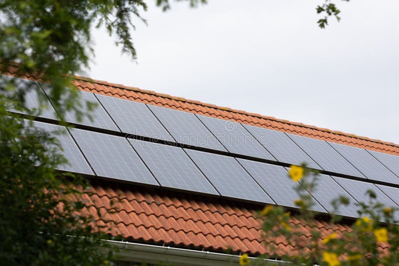 Solar panels installed on suburban house generating power during heat wave, aiding the green transition. Solar panels installed on suburban house generating power during heat wave, aiding the green transition.