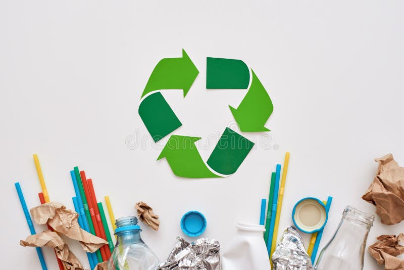 Sort your garbage. Crumple foil, paper and plastic are lying under recycle symbol. Different types of garbage unsorted. Sort your garbage. Crumple foil, paper and plastic are lying under recycle symbol. Different types of garbage unsorted
