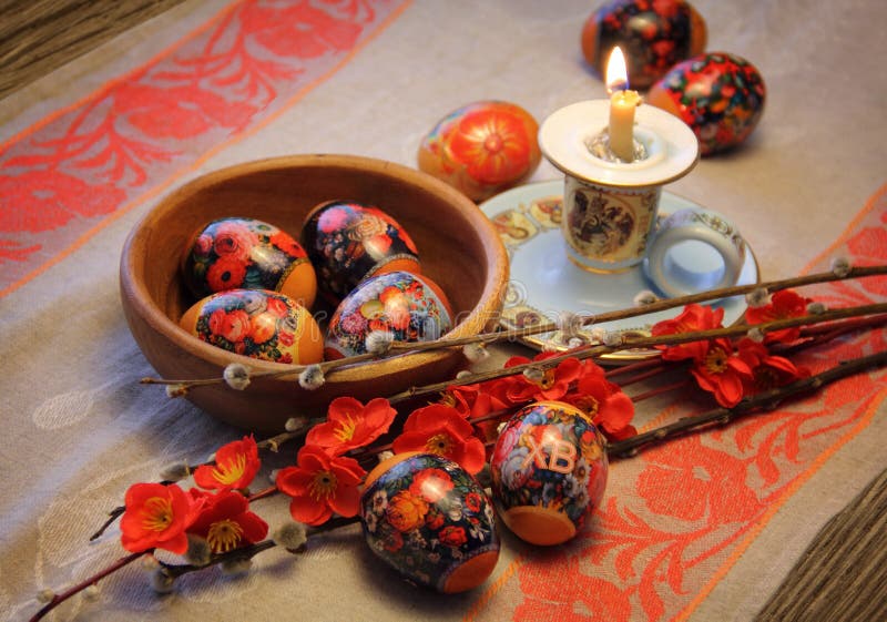 Easter composition: colorful eggs, willow branches, burned candle and linen towel - orthodox tradition. Easter composition: colorful eggs, willow branches, burned candle and linen towel - orthodox tradition