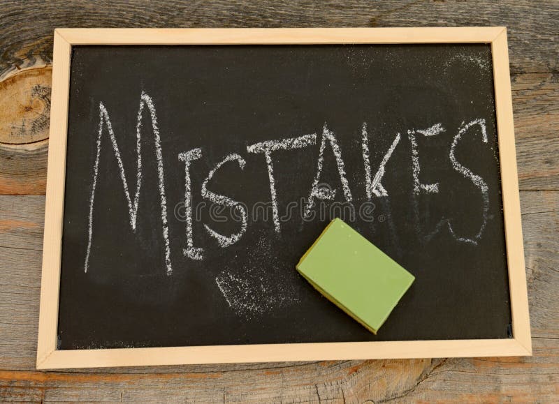 Erase or forget mistakes written in chalk on a chalkboard on a rustic background. Erase or forget mistakes written in chalk on a chalkboard on a rustic background