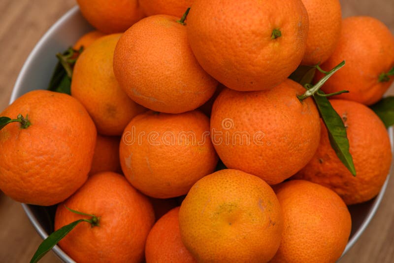 juicy tangerines in a plate on the table 2. juicy tangerines in a plate on the table 2