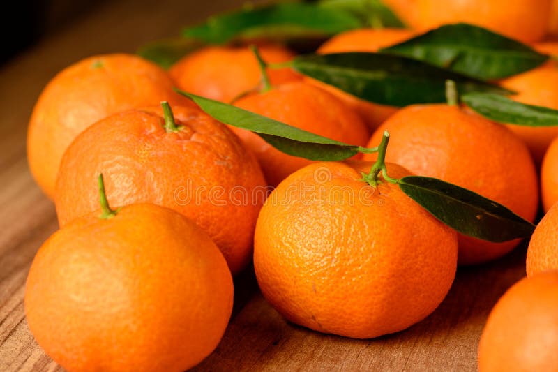 fresh juicy tangerines on a wooden table 2. fresh juicy tangerines on a wooden table 2