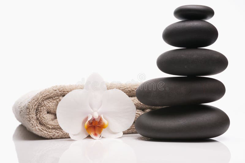 Spa stones towel and orchid on white background. Spa stones towel and orchid on white background