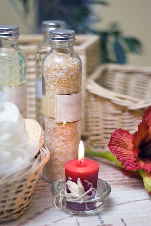 A spa composition consisting of three bottles and red elements (candle, flower). A spa composition consisting of three bottles and red elements (candle, flower).