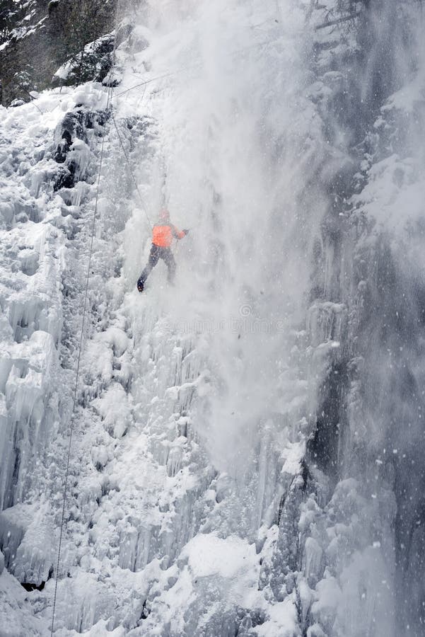 An avalanche is coming off, training of athletes on the frozen famous Manyavsky waterfall in Manyava - Ukraine, Carpathians before going to the Alps climbing expedition to the glaciers. An avalanche is coming off, training of athletes on the frozen famous Manyavsky waterfall in Manyava - Ukraine, Carpathians before going to the Alps climbing expedition to the glaciers