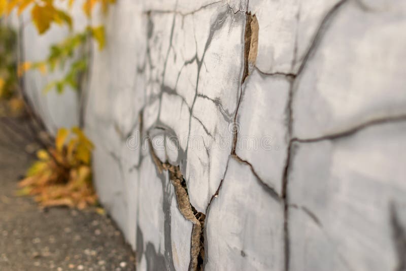 Cracks and chips on the ruined foundation of the old building structure. Cracks and chips on the ruined foundation of the old building structure