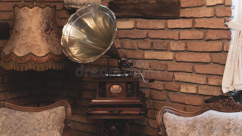 Antique music device vinyl record player old vintage gramophone with horn in elegant  living room. Antique music device vinyl record player old vintage gramophone with horn in elegant  living room